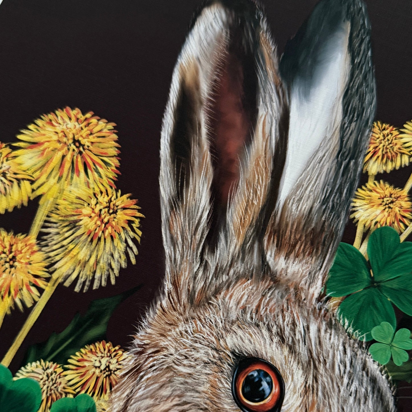 Detailed illustration of a rabbit with flowers and leaves on a dark background
